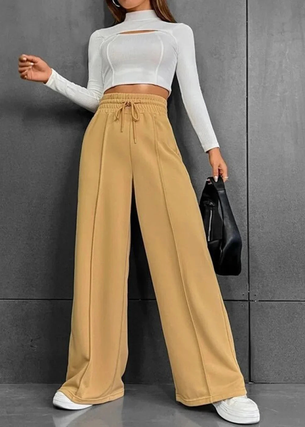Camel wide-leg pants with drawstring waist, and white crop top with cut-out detail.