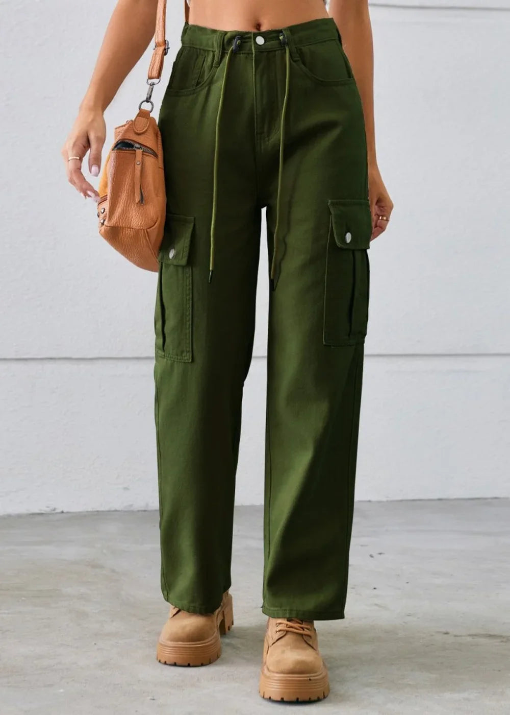 Woman in olive green cargo pants with drawstring waist and tan platform shoes.