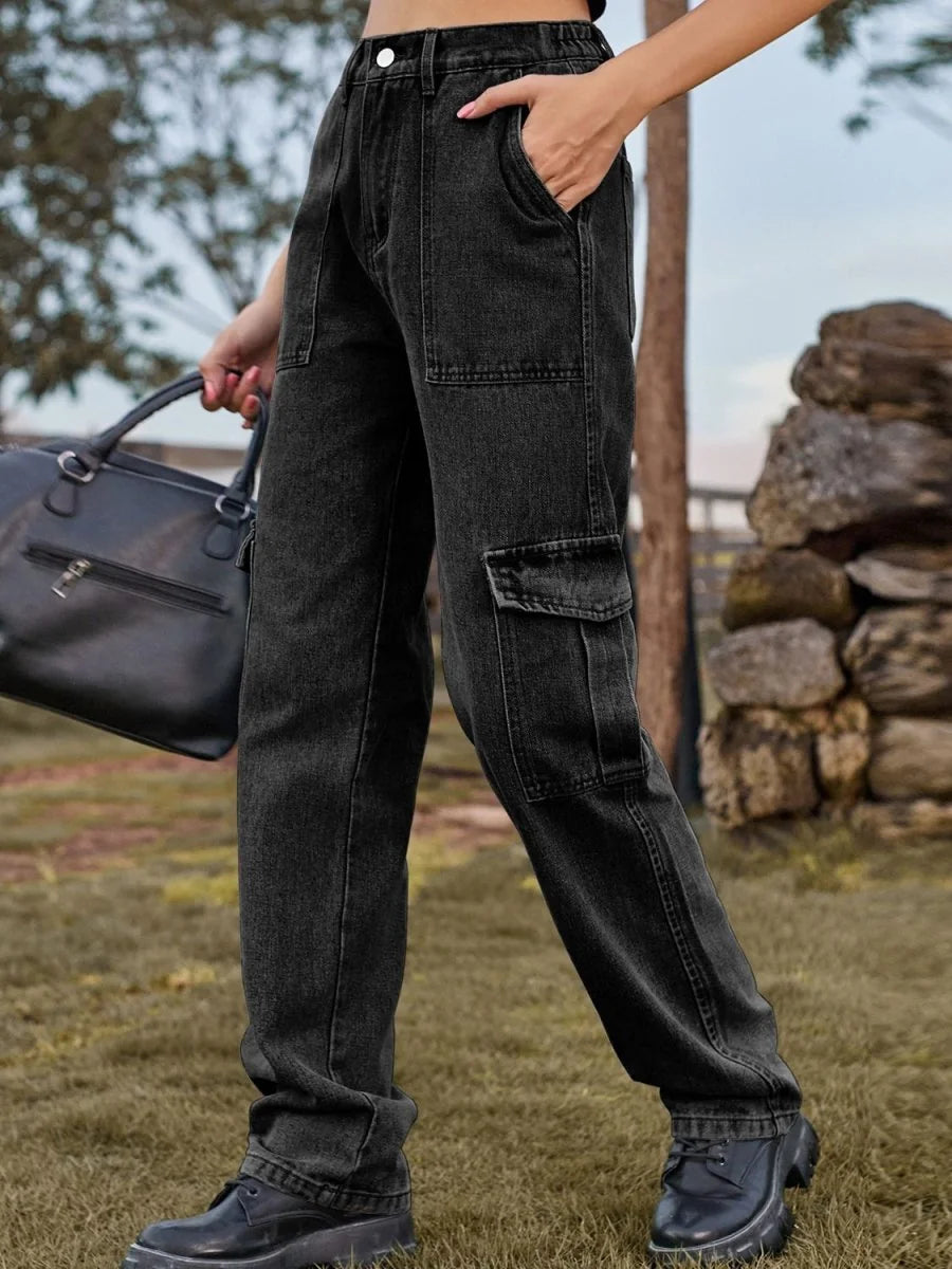 Close-up of dark wash, regular fit cargo jeans with utility pockets on model