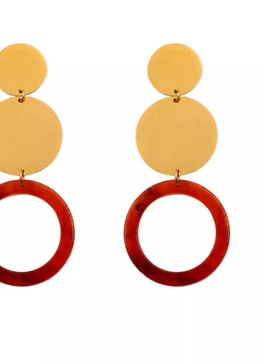 Gold disc earrings with red resin hoops.