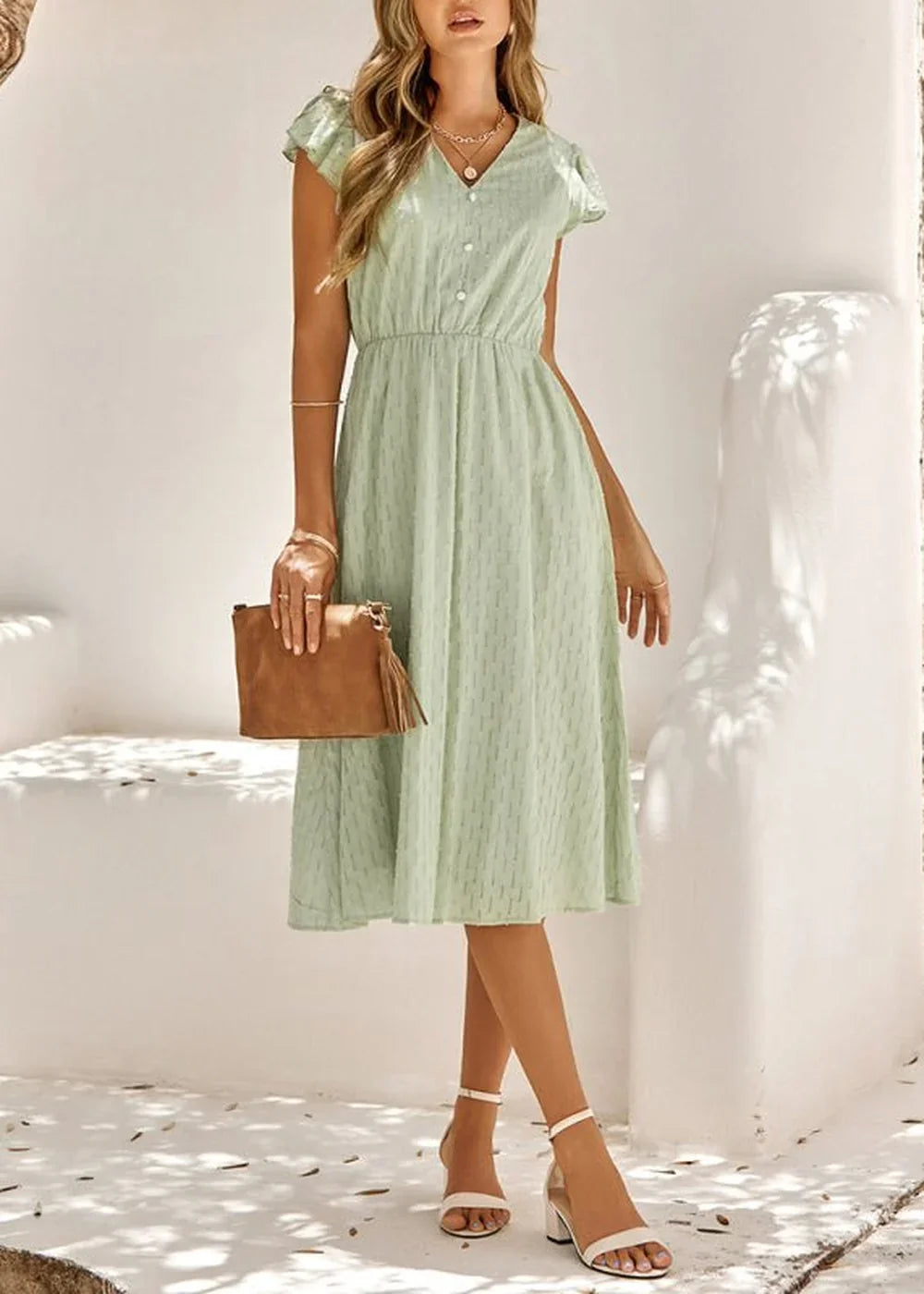 Light green cotton midi dress with v-neck, short flutter sleeves, and a small dot pattern.