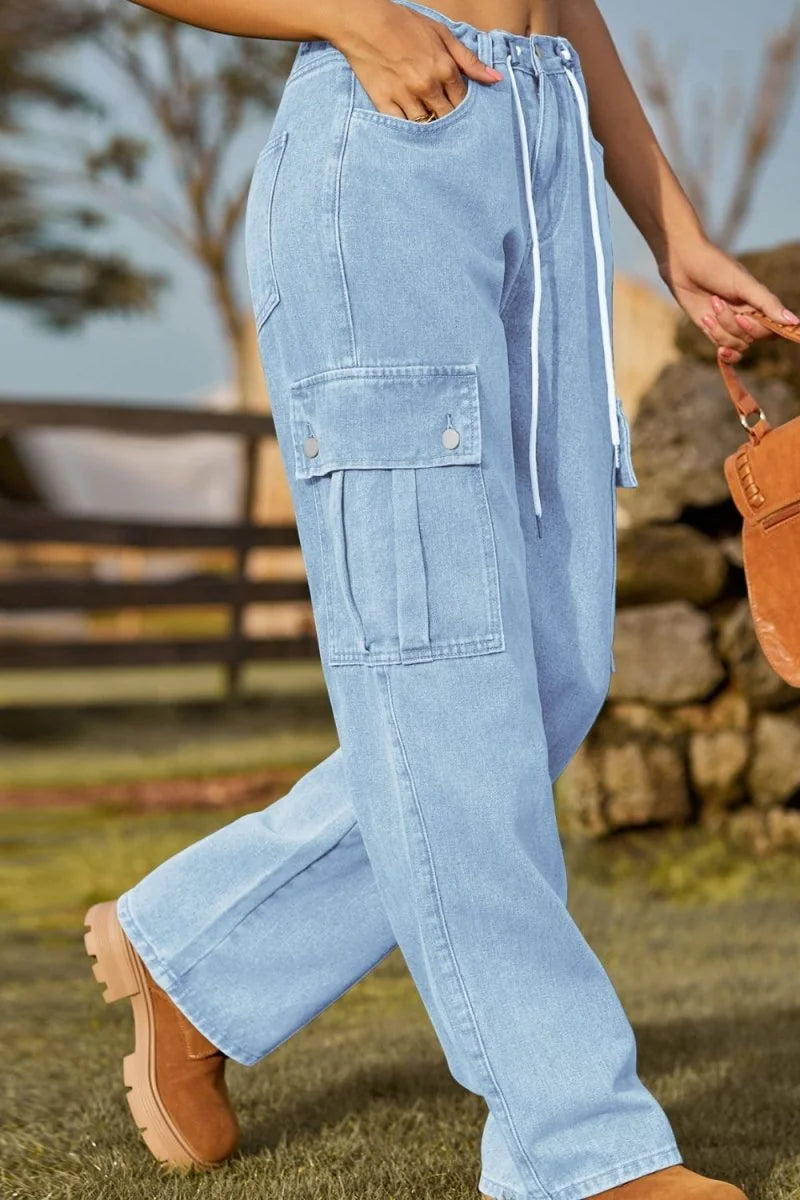 Light blue denim cargo pants with drawstring waist and pleated cargo pockets, worn by a model.