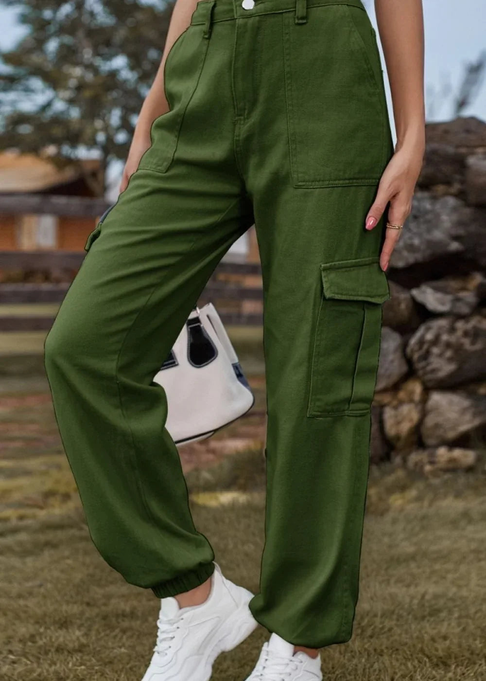 Olive green cargo pants with a regular fit and cuffed ankles, worn with white sneakers.