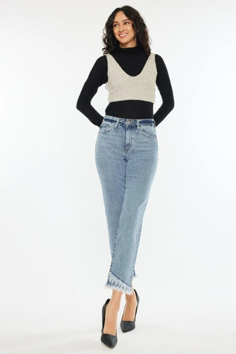 Light wash denim jeans with frayed hem and a regular fit on a model.