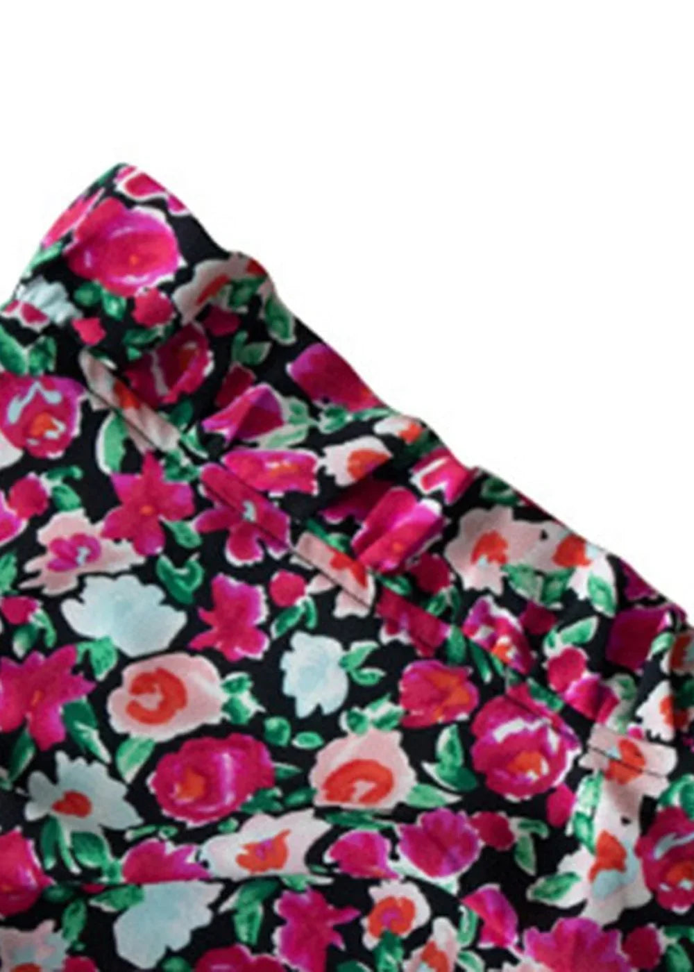 Close-up of a black top with a vibrant pink, red, and light blue floral print, showing fabric texture.