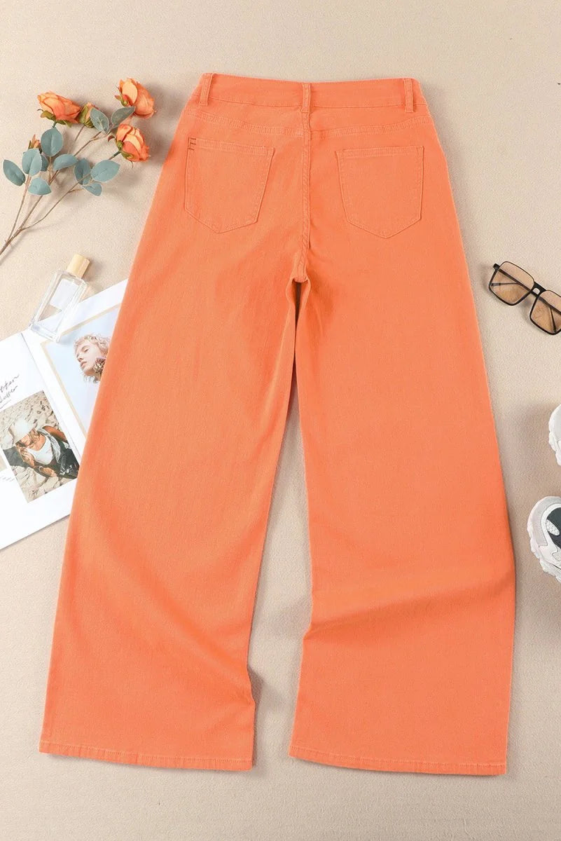 Orange wide-leg jeans with two back pockets and a relaxed fit.