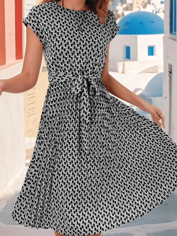 Black and white geometric print midi dress with short sleeves and a tie waist.