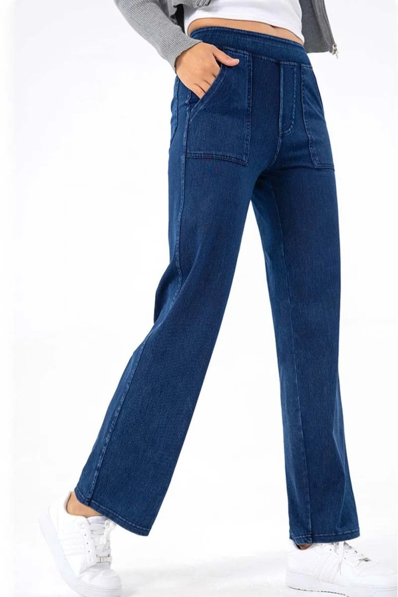 Navy blue denim pants with a regular fit and utility pockets on a model.