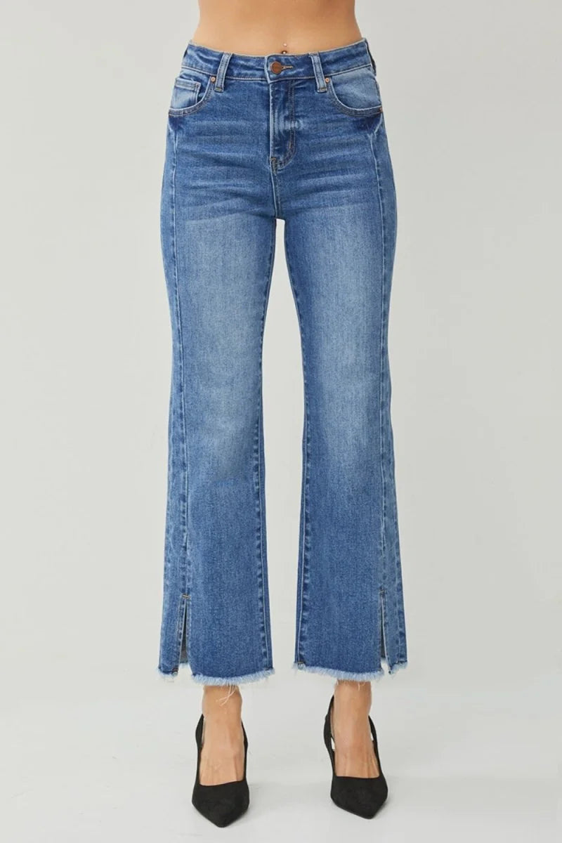 High-waisted blue denim flare jeans with frayed hem and side slits.