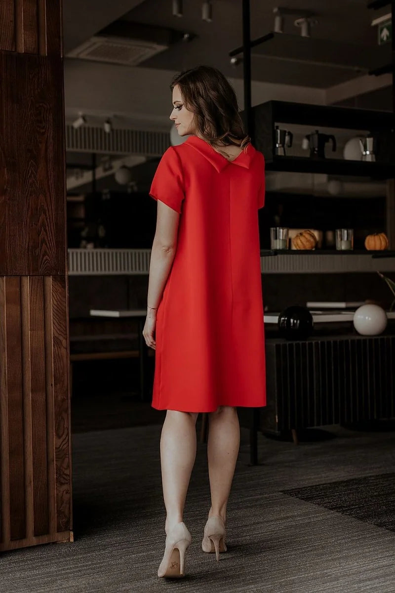 Red loose-fit short-sleeve dress with a V-neck and beige high heels on a model.
