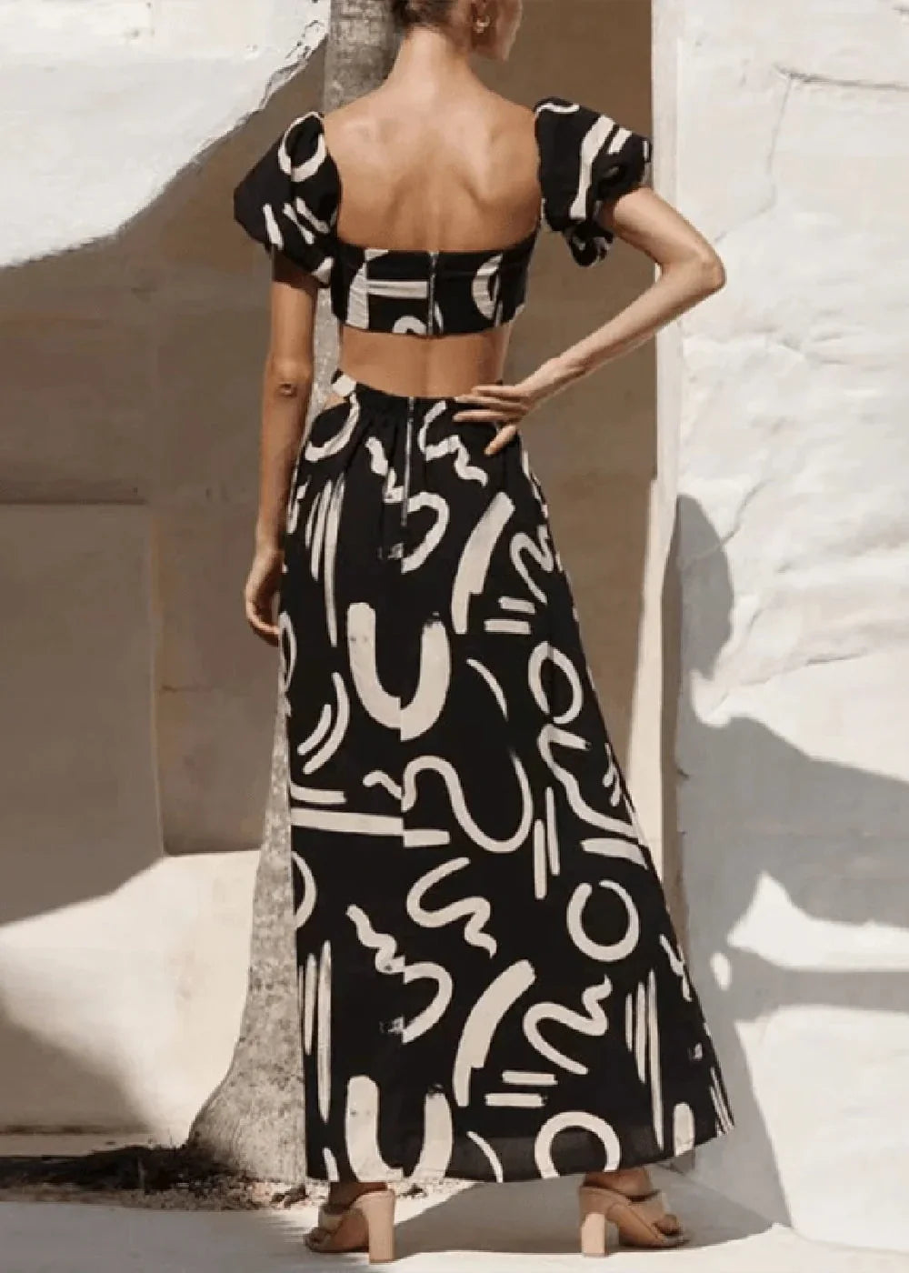 Black and white abstract print maxi skirt with a high waist and zipper closure on model.