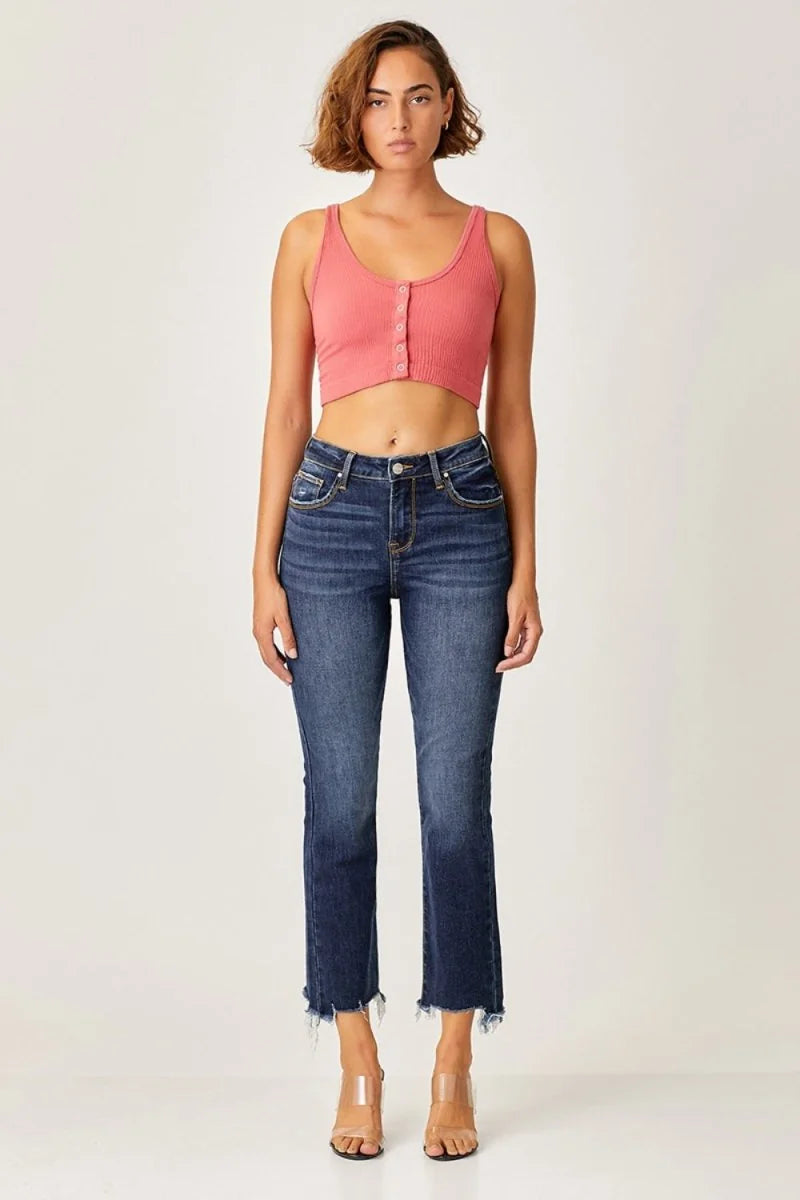 Dark wash denim jeans with frayed hems and subtle whiskering detail.