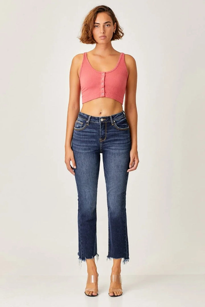 Dark wash denim jeans with frayed hems and subtle whiskering detail.