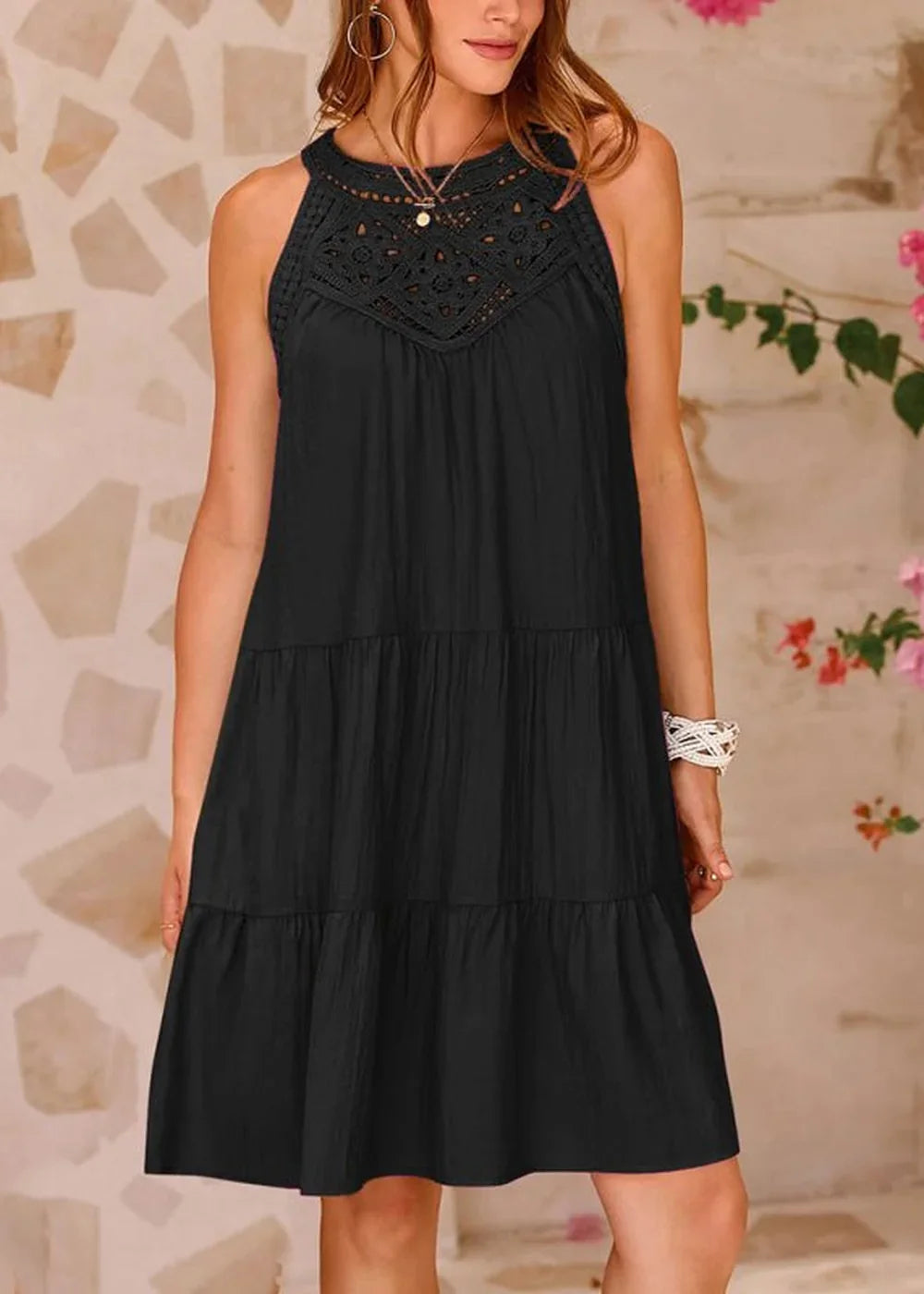 Black tiered dress with crochet neckline, on model.
