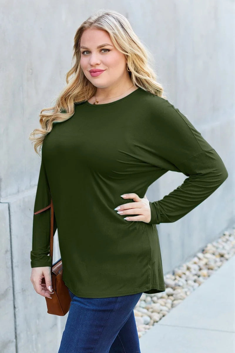 Olive green long-sleeve top with a relaxed fit, shown on a plus-size model.