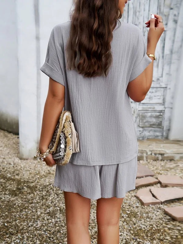 Light gray textured short suit with a loose-fit top and shorts, worn by a model.