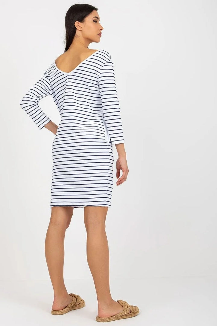 White and navy striped cotton-blend day dress with three-quarter sleeves and V-neckline on model.