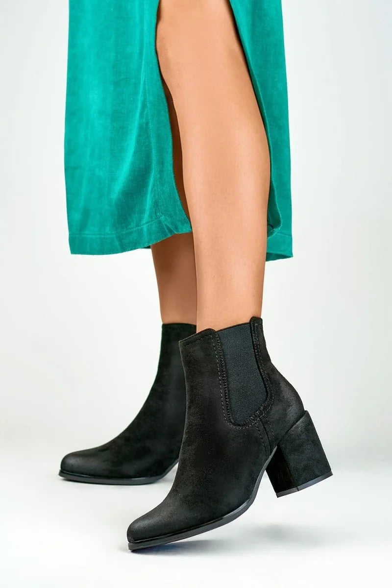 Black eco-leather ankle boots with a block heel and elastic side panels.