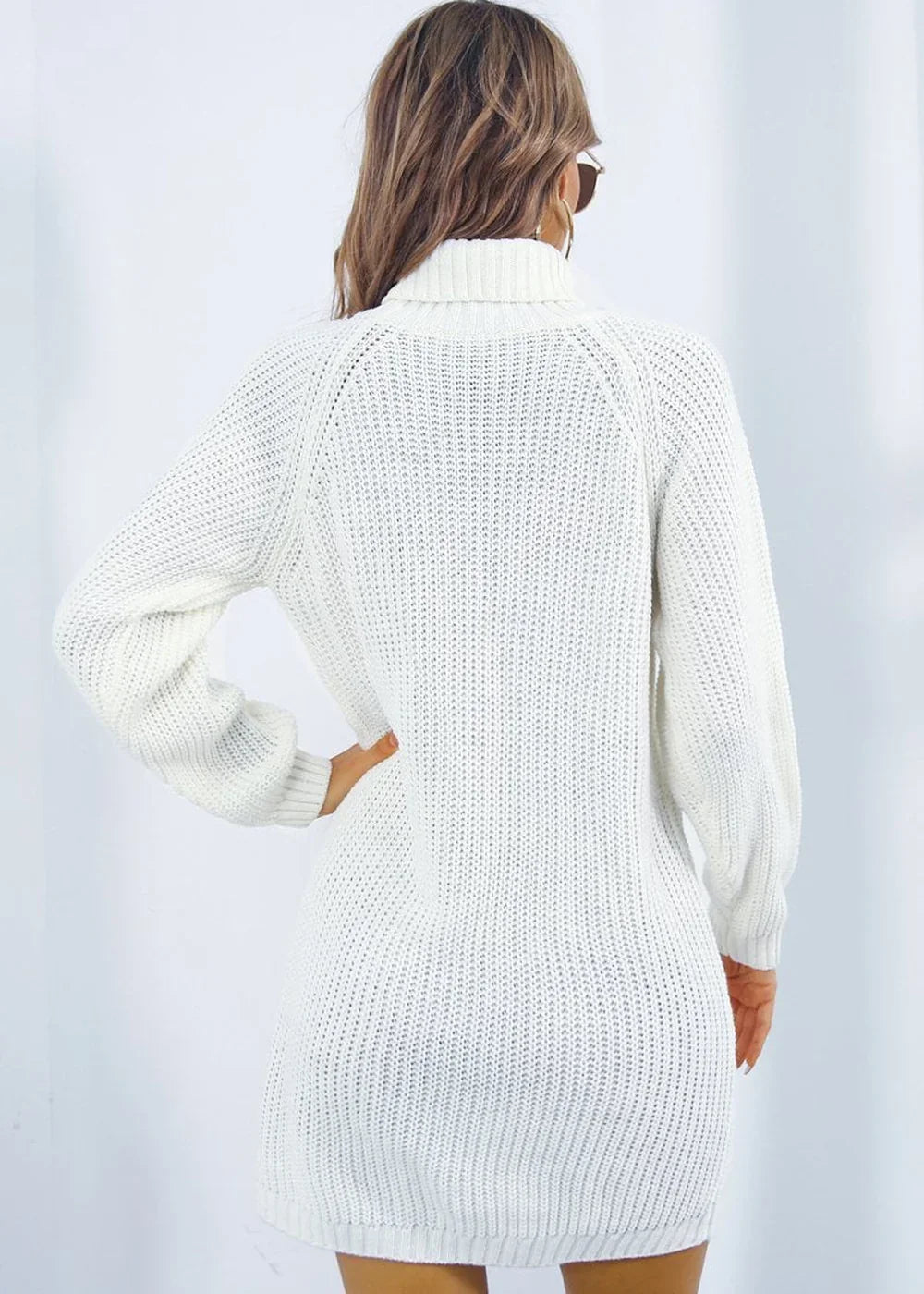 White acrylic knit turtleneck sweater dress with long sleeves, shown from the back on a model.