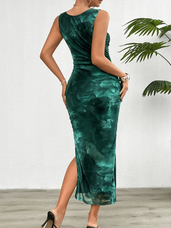 Woman in a sleeveless, emerald green tie-dye maxi dress with a thigh-high slit and ruched detailing.