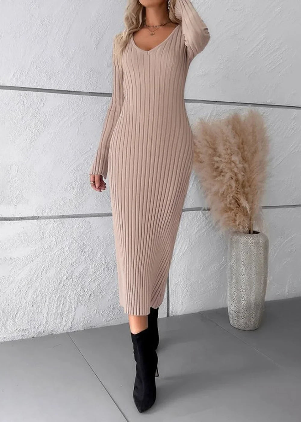 Khaki ribbed knit sweater dress with long sleeves and v-neck, worn by a model with black boots.