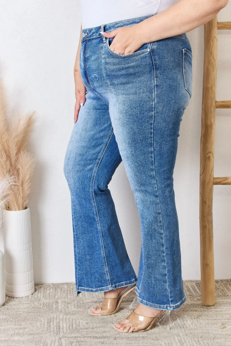 Medium wash flared jeans with a regular fit, detailed with pockets and a frayed hem.