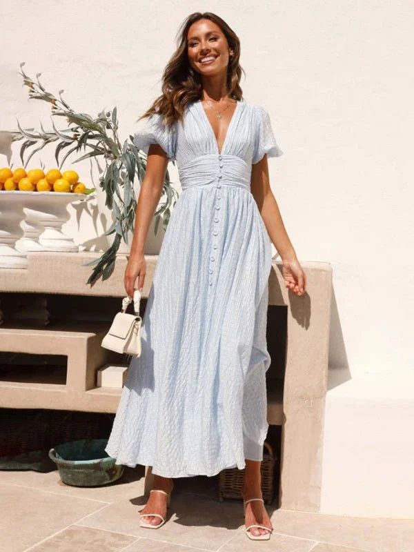 Light blue textured V-neck maxi dress with button front, on model.