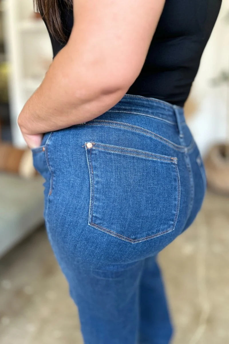 Close-up of the back pocket of medium wash denim jeans with a regular fit.