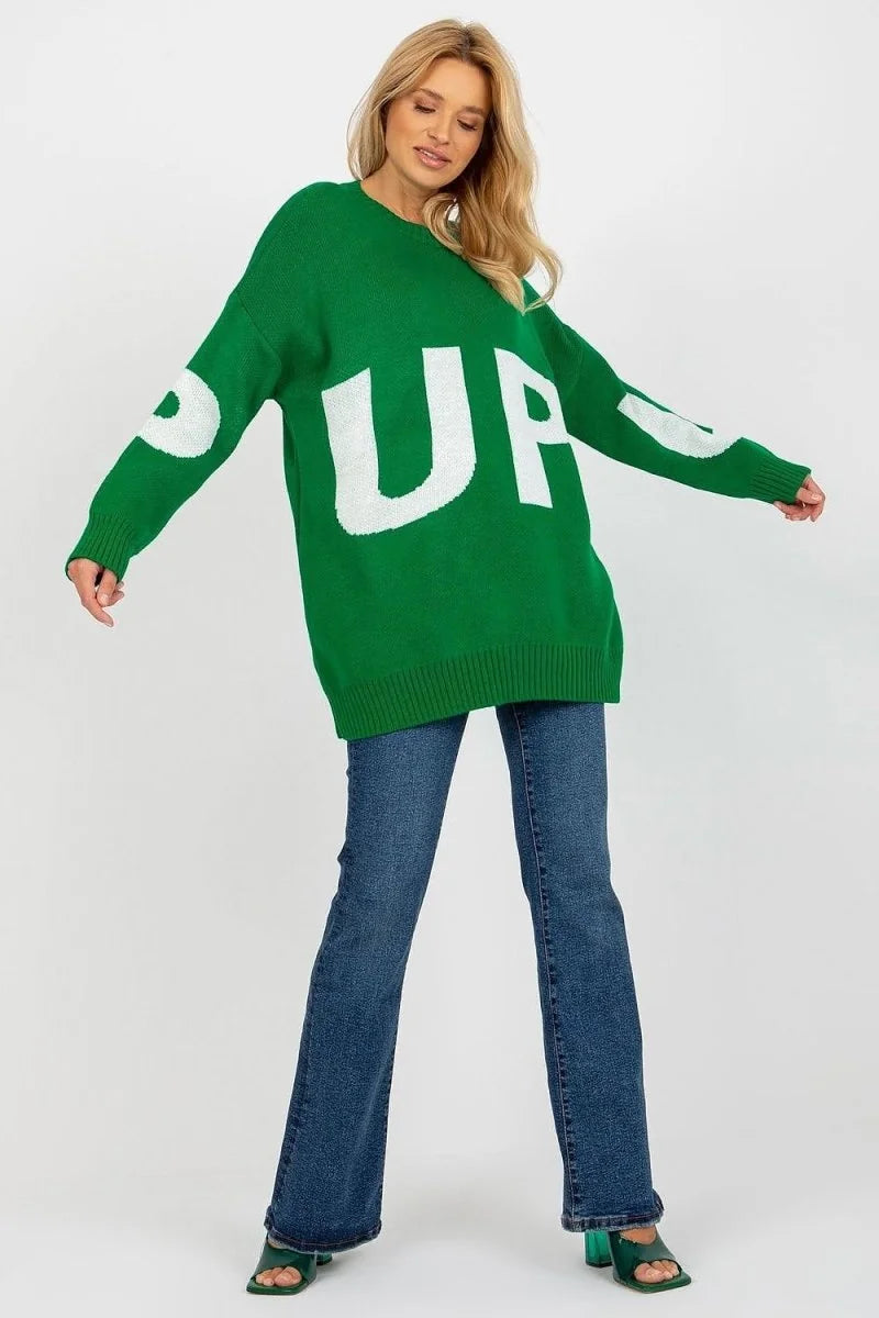 Green oversized sweater with white "UP" graphic print and flared jeans on model.
