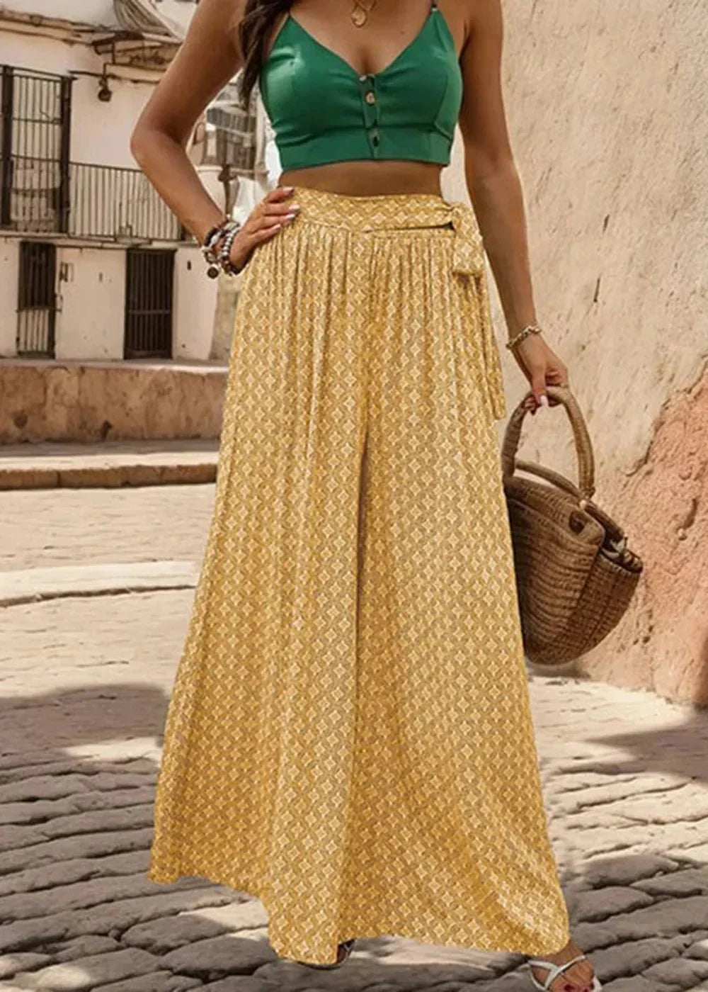 Yellow wide-leg pants with a geometric print and a tie waist.