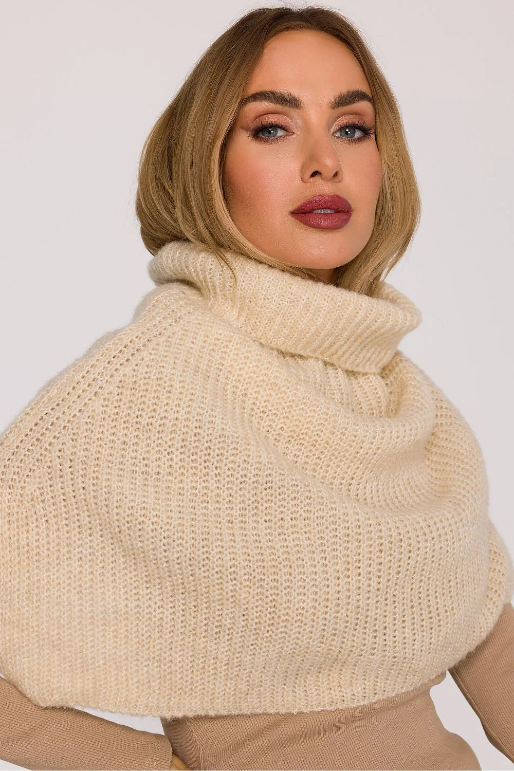 Cream-colored, fuzzy knit turtleneck sweater with a wide collar, worn by a model.