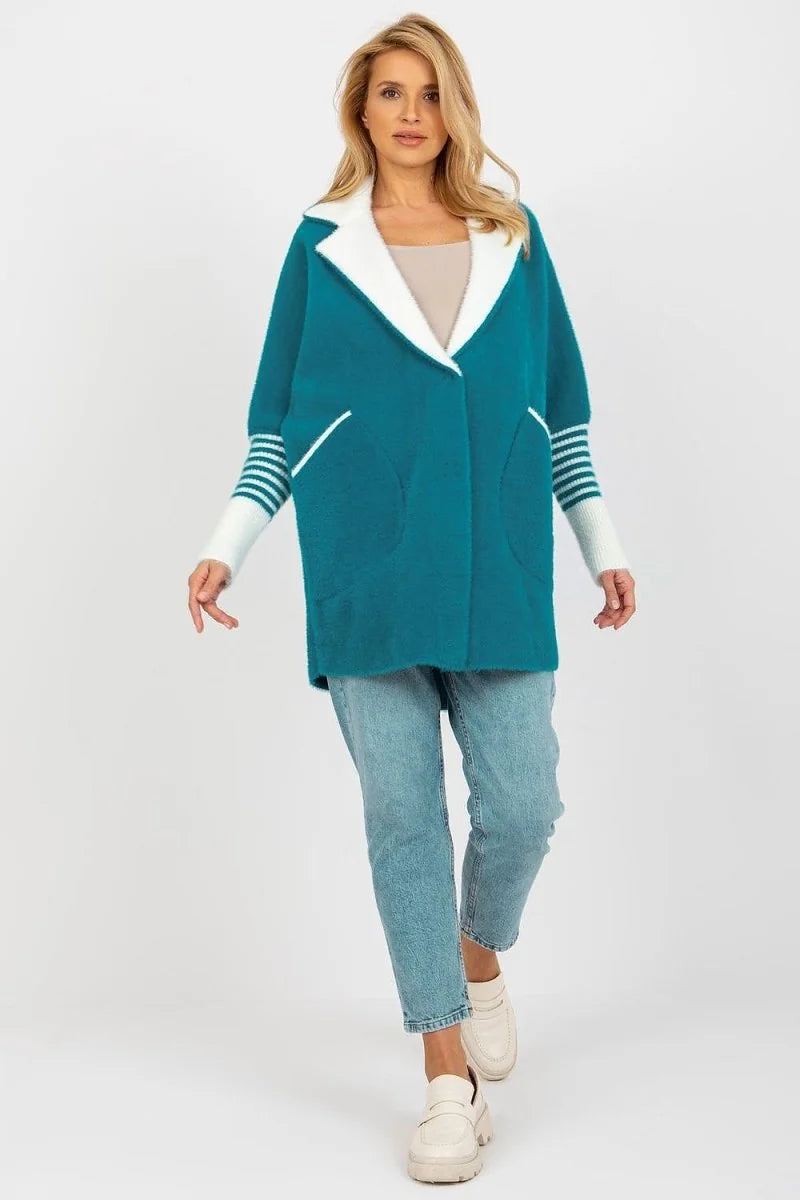 Teal angora blend jacket with white collar and striped cuffs, worn by a model with light wash jeans.