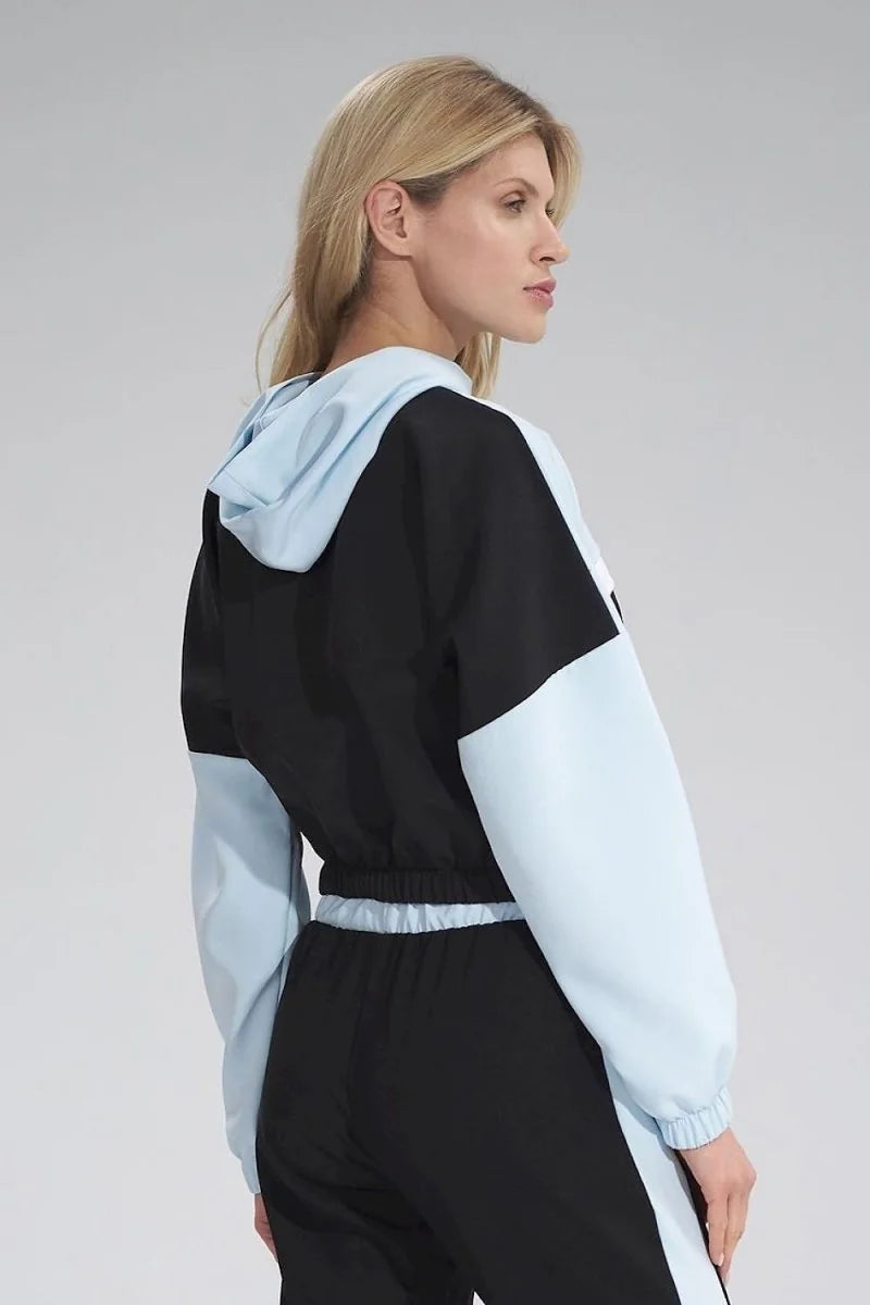 Black and light blue color-blocked cropped hoodie with a drawstring waist on a model.