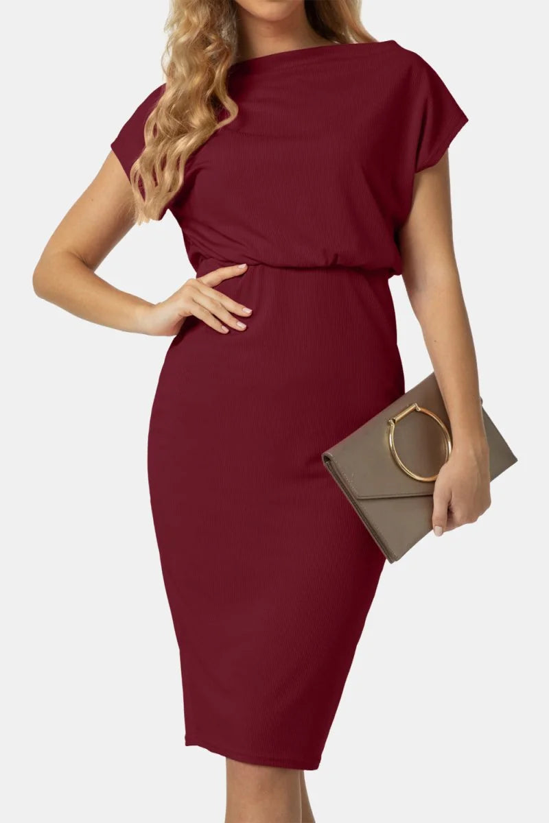 Burgundy ribbed knit dress with cap sleeves and a gold-accented clutch.