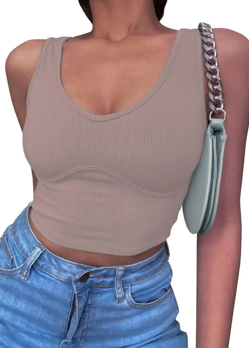 Light tan ribbed knit crop top with a V-neck and structured bust detail, worn with light wash denim jeans.