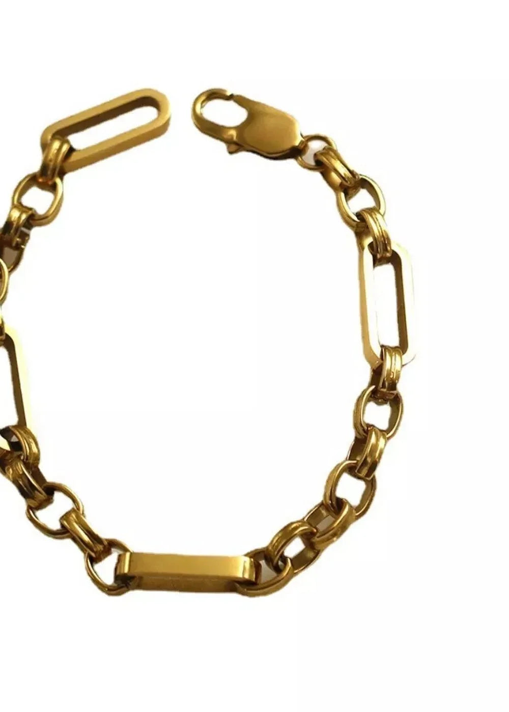 Close-up of a gold-toned chain bracelet with interlocking oblong and round links, featuring a lobster clasp.