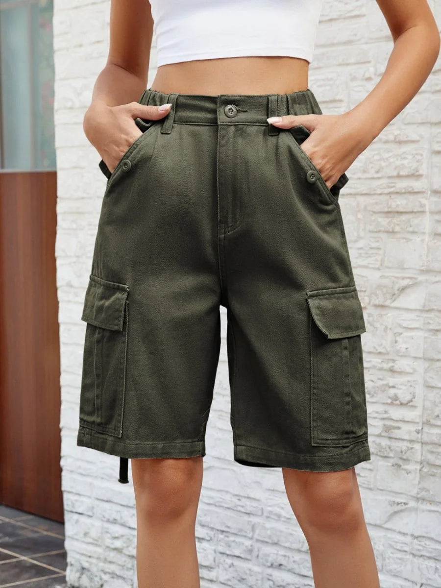 Olive green cargo shorts with button and pocket details, on a model.