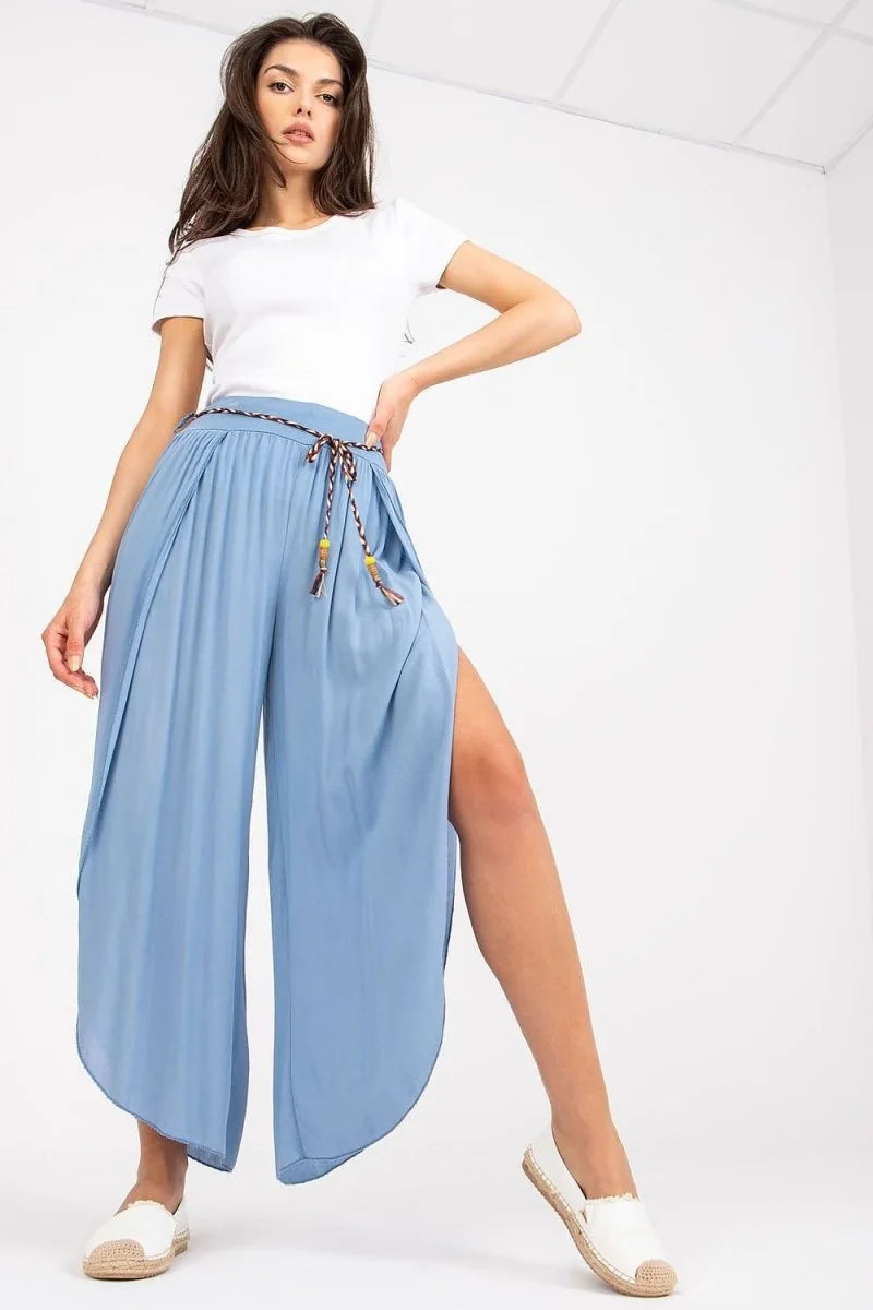 Light blue wide-leg pants with high slits and a braided belt, on a model.