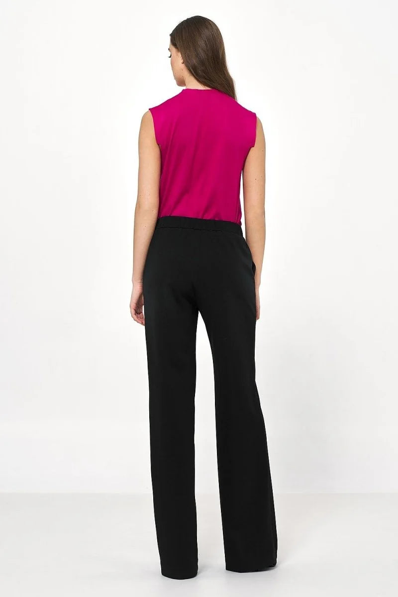 Back view of black, relaxed-fit, wide-leg trousers with a smooth texture.