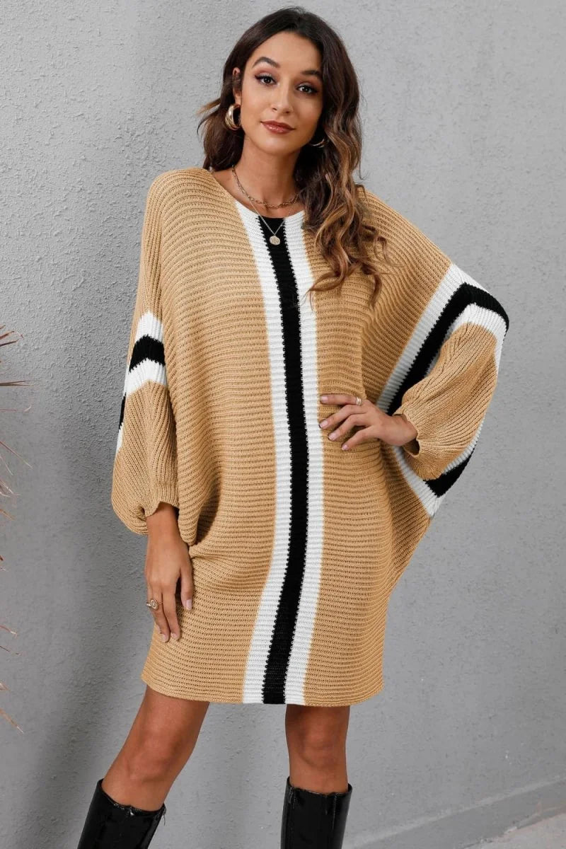 Camel knit sweater dress with vertical black and white stripes and dolman sleeves on model.