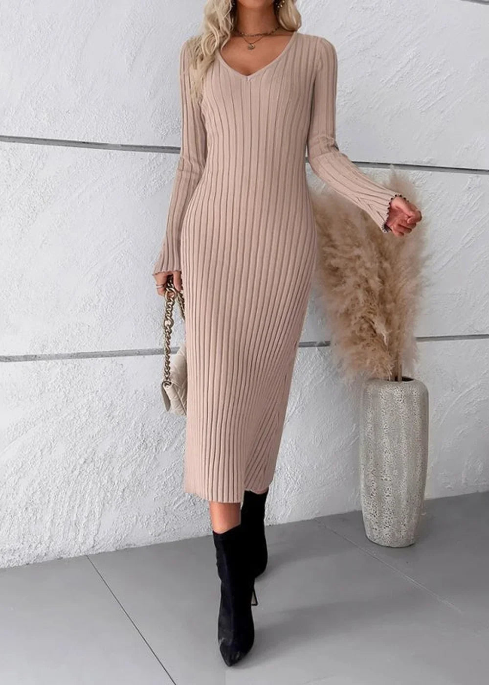 Khaki ribbed V-neck midi sweater dress with long sleeves, worn by a model with black boots and a cream purse.