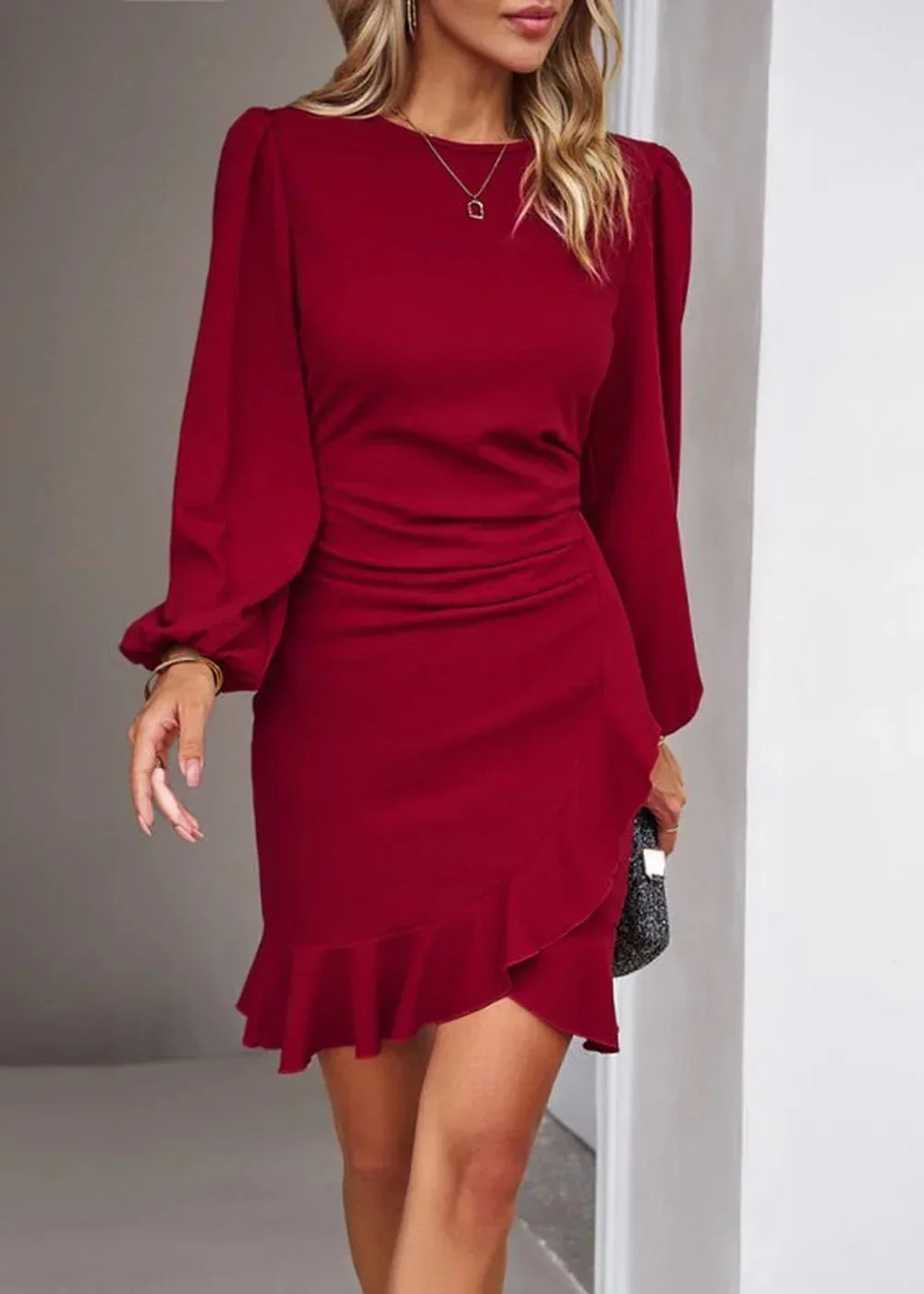 Red ruched mini dress with ruffled hem and puff sleeves, worn by a model.