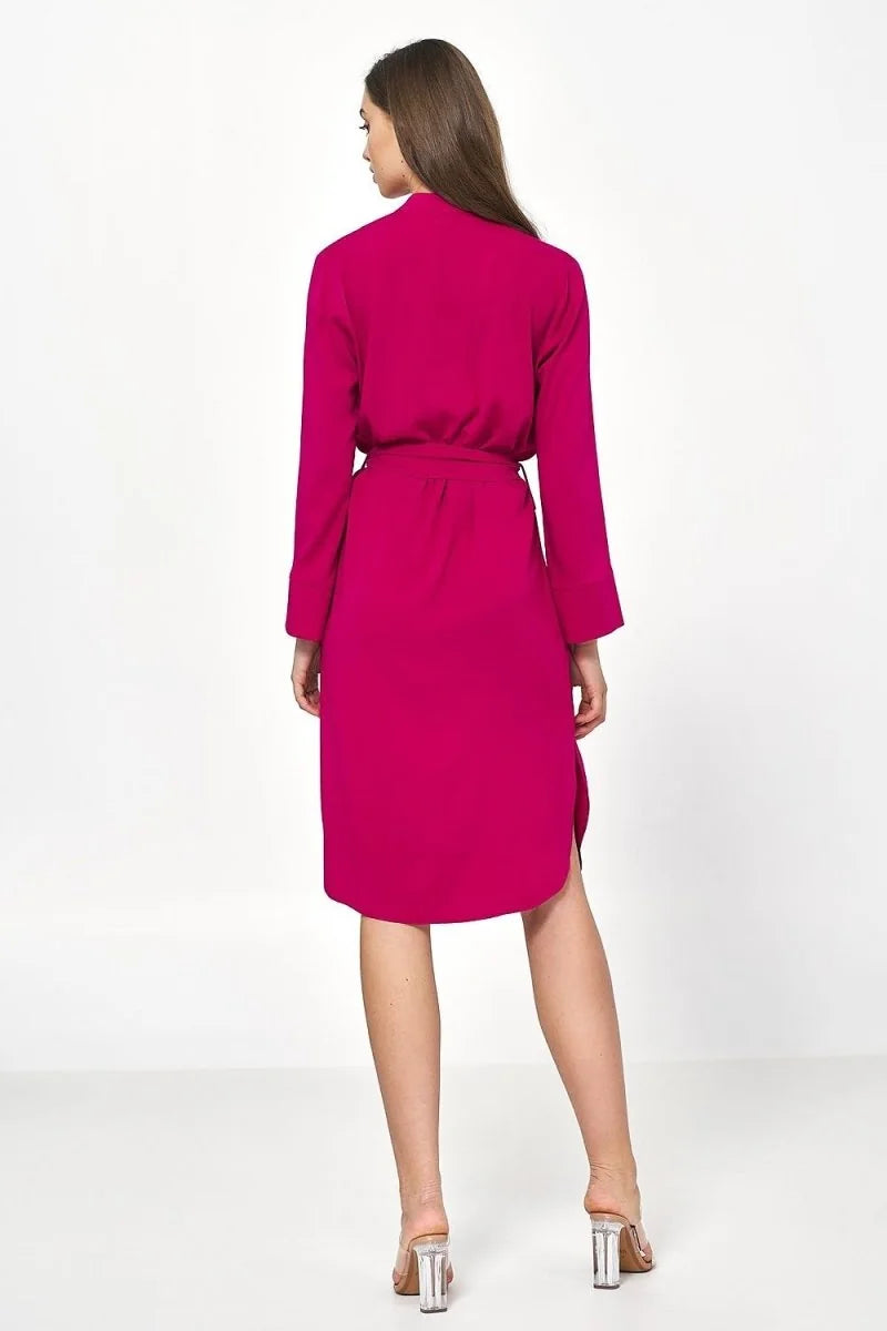 Back view of a bright pink viscose dress with a belt and clear block heels.