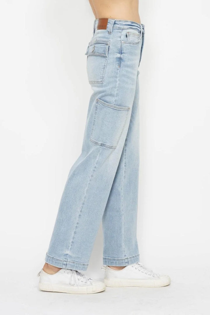 Light wash denim jeans with cargo pockets and white sneakers.