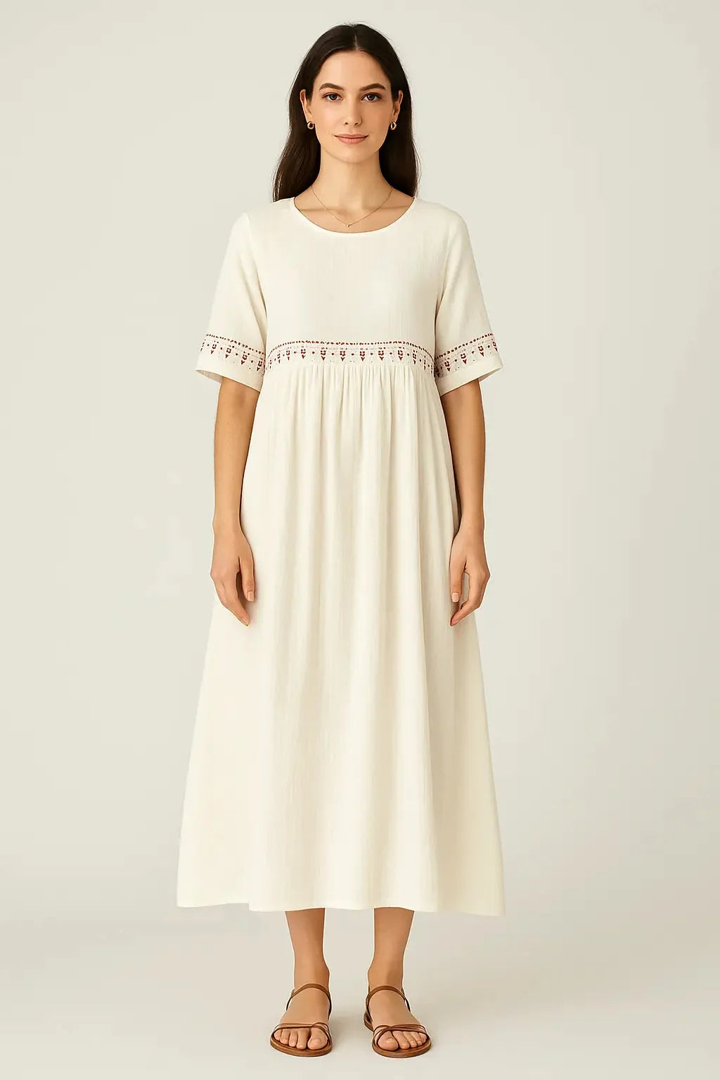 Cream midi dress with embroidered neckline and sleeves, worn by a model with brown sandals.