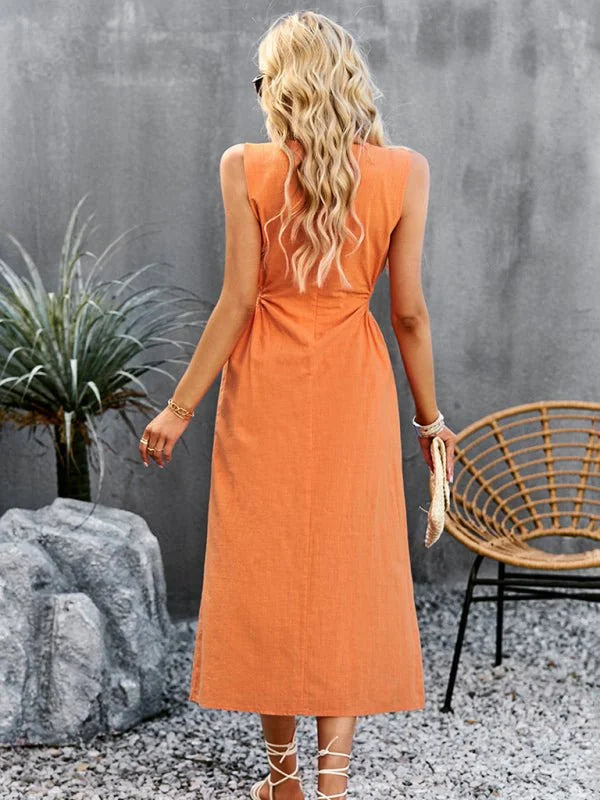 Orange sleeveless midi dress with tie-up sandals and gold jewelry.