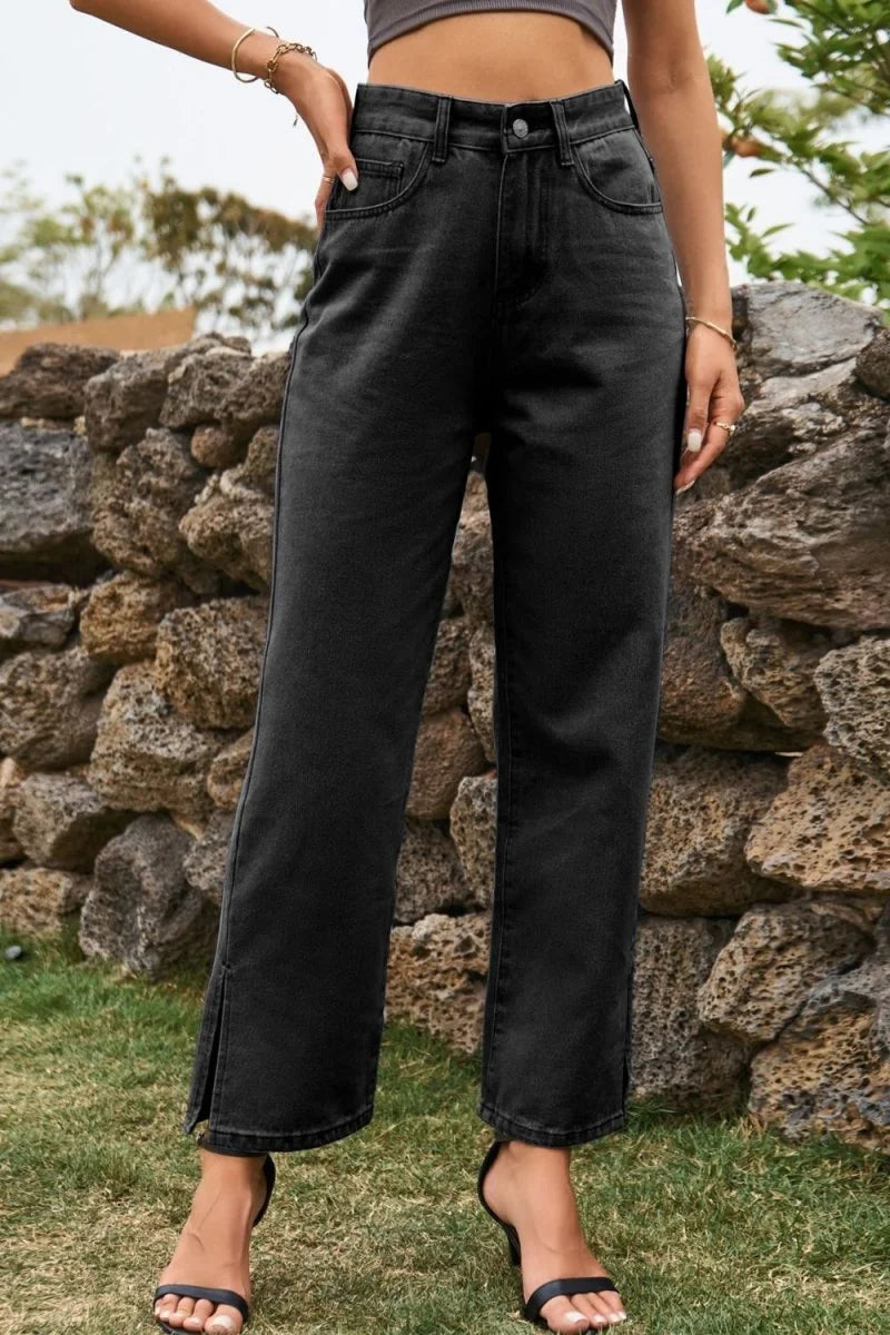 Black denim wide-leg pants with side slits and a regular fit, shown on a model.