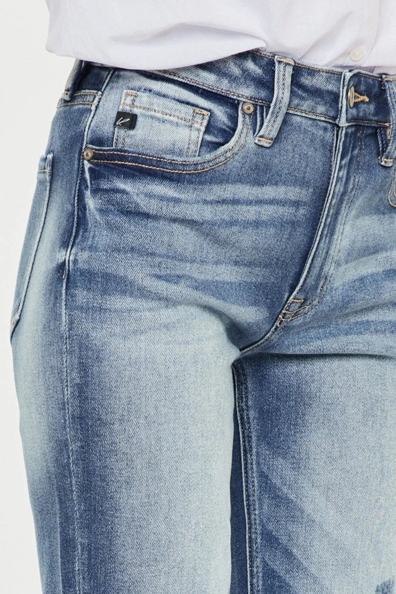 Close-up of light blue distressed denim jeans with a regular fit, showing texture and faded details.