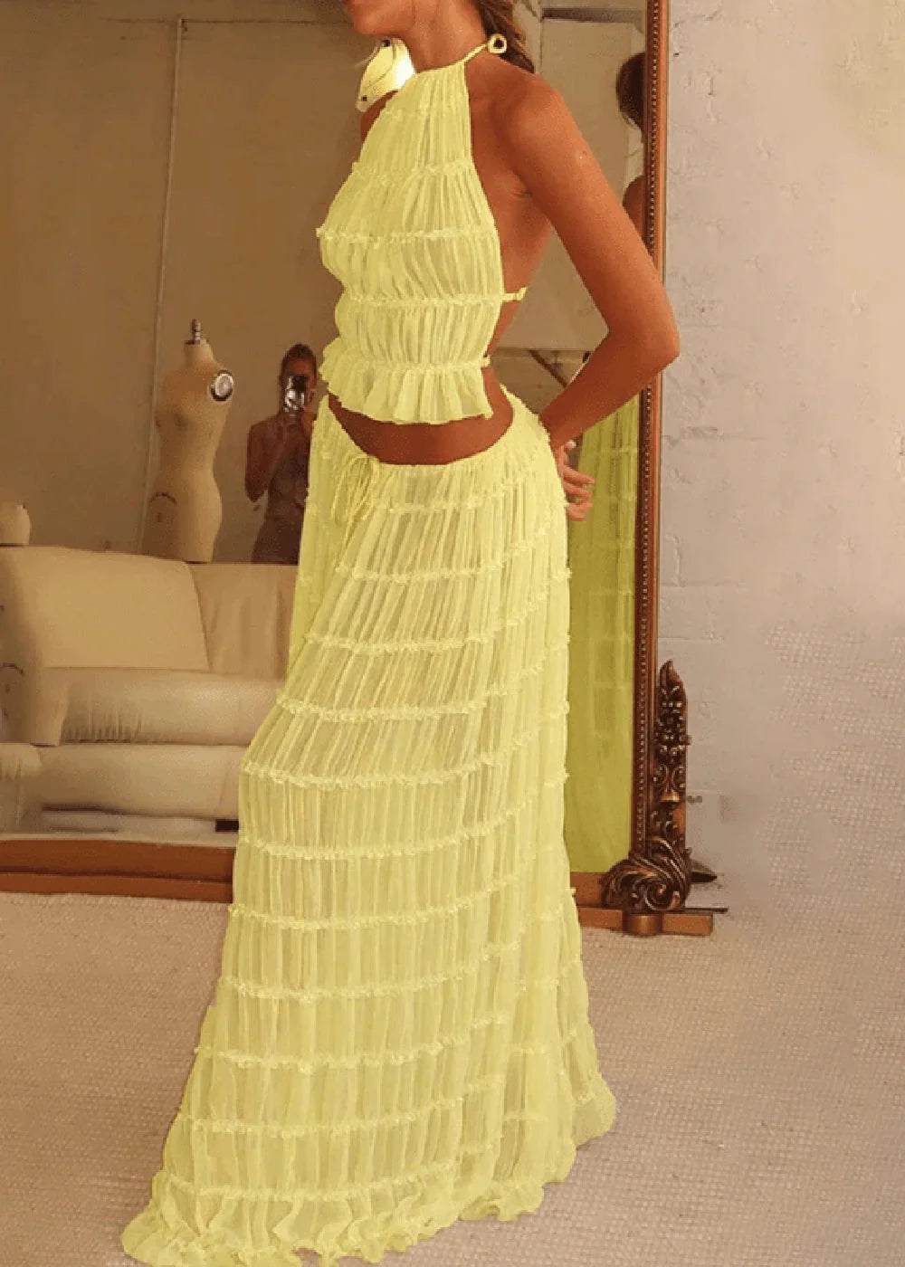 Yellow ruffled halter top and matching tiered maxi skirt set.