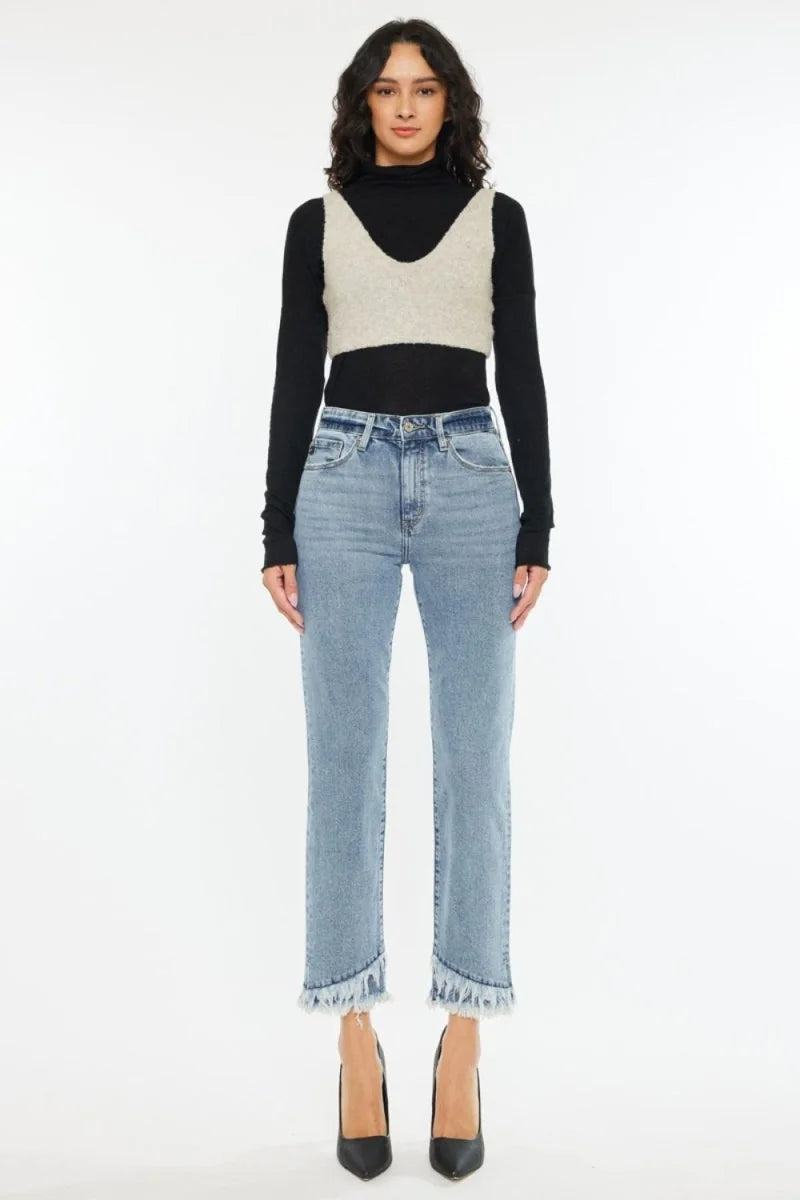 Light wash denim jeans with frayed hems, on model.